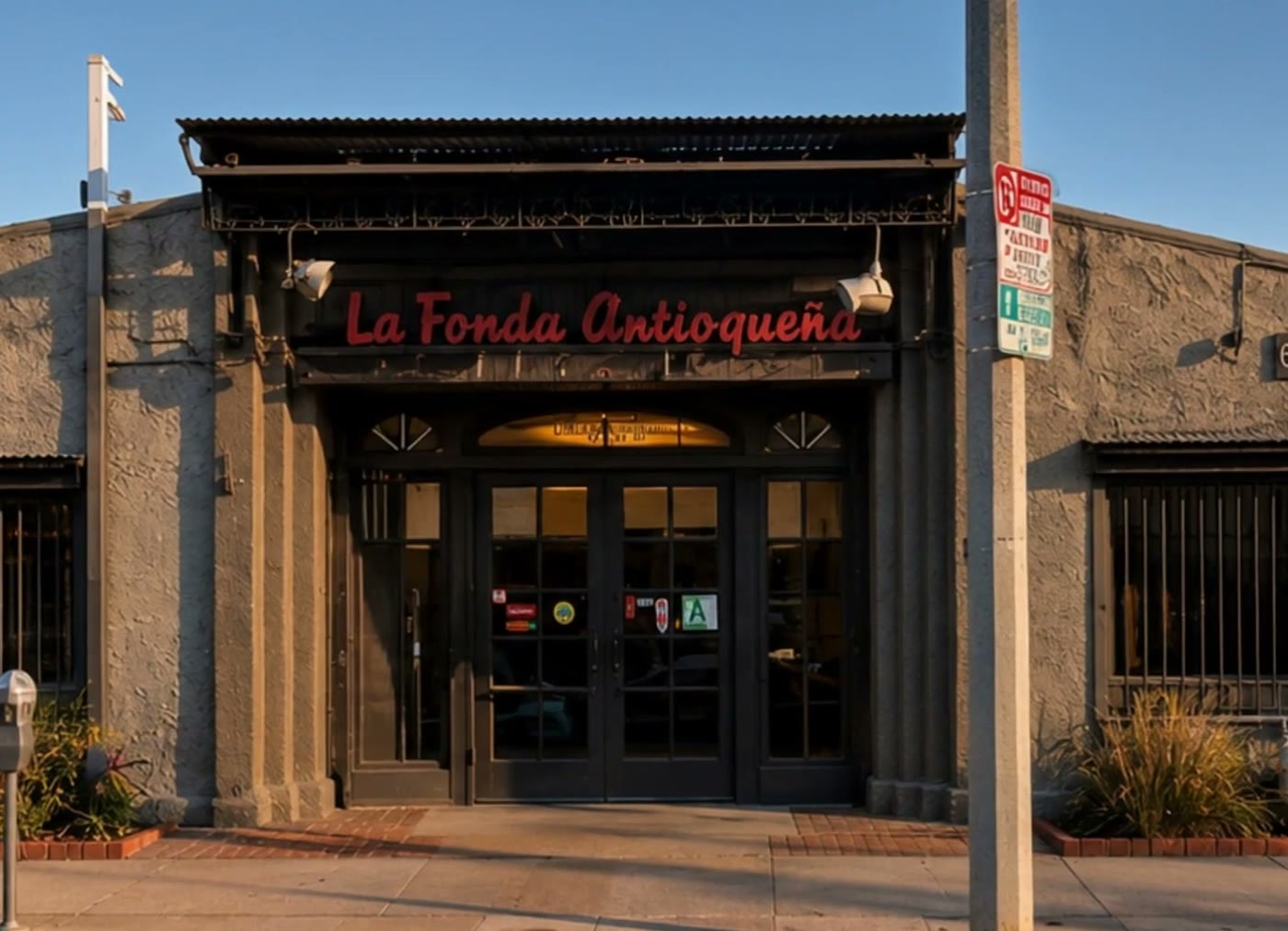The front doors of La Fonda Antioqueña under warm evening light