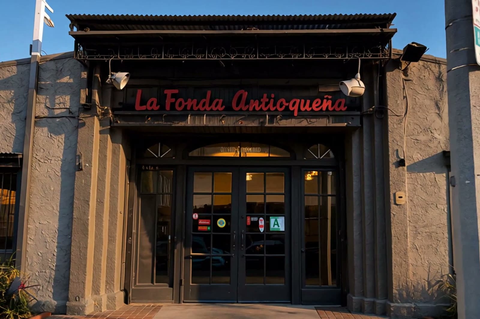 The red La Fonda Antioqueña lettering over the entrance at golden hour